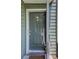 A close up view of the front door, showing the unit number, door knocker, handles, and the security lock at 4604 Vinings Central Se Run # 131, Atlanta, GA 30339