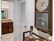 Hallway with hardwood flooring, a large clock, and a view into a bathroom at 4604 Vinings Central Se Run # 131, Atlanta, GA 30339