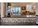 Open-concept living space with breakfast bar overlooking a cozy room featuring a fireplace and an adjacent office space at 4604 Vinings Central Se Run # 131, Atlanta, GA 30339