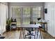 Bright home office with a large window, wood floors, and a practical workspace, ideal for remote work or study at 4604 Vinings Central Se Run # 131, Atlanta, GA 30339