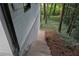 View of home's wooded backyard with surrounding brick and siding at 772 Brookwood Sw Ter, Lilburn, GA 30047