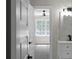 Bathroom with modern fixtures that leads into the carpeted bedroom and window view at 772 Brookwood Sw Ter, Lilburn, GA 30047
