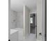 Bathroom featuring a tub with marble tiling, a built-in niche, and a white vanity at 772 Brookwood Sw Ter, Lilburn, GA 30047