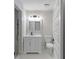 Modern bathroom features a marble vanity, black faucet, and tiled shower with a glass door at 772 Brookwood Sw Ter, Lilburn, GA 30047