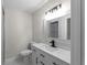 Bathroom featuring sleek vanity, faucet, and toilet at 772 Brookwood Sw Ter, Lilburn, GA 30047