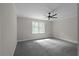 Spacious bedroom with new carpeting, large windows, and modern ceiling fan at 772 Brookwood Sw Ter, Lilburn, GA 30047