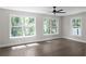 Bedroom featuring large windows, hardwood floors, neutral paint, and a ceiling fan at 772 Brookwood Sw Ter, Lilburn, GA 30047