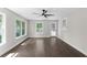 Bedroom features hardwood floors, white trim, and large windows that flood the space with light at 772 Brookwood Sw Ter, Lilburn, GA 30047