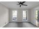 Bedroom with neutral paint and carpet with two windows at 772 Brookwood Sw Ter, Lilburn, GA 30047