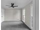 Cozy bedroom with plush gray carpeting, neutral paint, and bright windows at 772 Brookwood Sw Ter, Lilburn, GA 30047