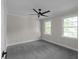 Spacious carpeted bedroom featuring natural light with a modern ceiling fan at 772 Brookwood Sw Ter, Lilburn, GA 30047