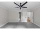 This bedroom has neutral walls, new carpet, crown molding, and a modern ceiling fan at 772 Brookwood Sw Ter, Lilburn, GA 30047