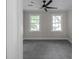 Bright bedroom with natural light, neutral walls, new carpet, and a modern ceiling fan at 772 Brookwood Sw Ter, Lilburn, GA 30047