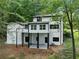 A partial view of the two-story home with black trim at 772 Brookwood Sw Ter, Lilburn, GA 30047
