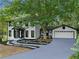 Charming two-story home with a large, well-maintained front yard and attached two car garage at 772 Brookwood Sw Ter, Lilburn, GA 30047