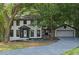 Charming two-story home featuring a well-manicured lawn, attached garage, and inviting front entrance at 772 Brookwood Sw Ter, Lilburn, GA 30047