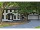 Charming two-story home featuring a well-manicured lawn, attached garage, and inviting front entrance at 772 Brookwood Sw Ter, Lilburn, GA 30047