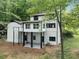 Two-story home with black trim and surrounding woods at 772 Brookwood Sw Ter, Lilburn, GA 30047