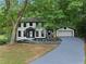 Charming two-story home with a large, well-maintained front yard and attached two car garage at 772 Brookwood Sw Ter, Lilburn, GA 30047