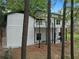 View of the two-story home with side yard at 772 Brookwood Sw Ter, Lilburn, GA 30047