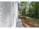 View of home's siding and small back porch area overlooking the wooded yard at 772 Brookwood Sw Ter, Lilburn, GA 30047