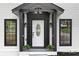 Close up of the home's front entrance, featuring black accents and meticulous landscaping at 772 Brookwood Sw Ter, Lilburn, GA 30047