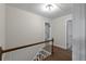 Bright hallway with hardwood floors, neutral paint, and white trim leads to the bedrooms at 772 Brookwood Sw Ter, Lilburn, GA 30047