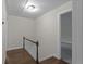 Upstairs hallway featuring hardwood floors, neutral walls, and easy access to the bedrooms at 772 Brookwood Sw Ter, Lilburn, GA 30047