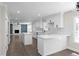 Modern kitchen with white cabinetry, quartz countertops, stainless steel appliances, and an open floor plan at 772 Brookwood Sw Ter, Lilburn, GA 30047