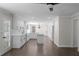 Spacious kitchen with white cabinets, marble countertops, hardwood floors, and modern lighting fixtures at 772 Brookwood Sw Ter, Lilburn, GA 30047