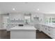 Bright kitchen with white cabinets, quartz countertops, subway tile backsplash, and a center island at 772 Brookwood Sw Ter, Lilburn, GA 30047