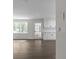Open kitchen with hardwood floors, white cabinets, and natural light at 772 Brookwood Sw Ter, Lilburn, GA 30047