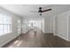 Open-concept kitchen and living room space with hardwood floors and modern fixtures at 772 Brookwood Sw Ter, Lilburn, GA 30047