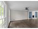 Living room showcases wood flooring, natural light, a modern ceiling fan, and unique fireplace at 772 Brookwood Sw Ter, Lilburn, GA 30047