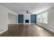 Spacious living room with fireplace, large windows, and hardwood floors at 772 Brookwood Sw Ter, Lilburn, GA 30047