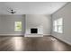 Bright living room with a fireplace, big windows, and ceiling fan at 772 Brookwood Sw Ter, Lilburn, GA 30047
