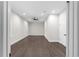 Open living room featuring hardwood floors, modern ceiling fan, and neutral paint at 772 Brookwood Sw Ter, Lilburn, GA 30047