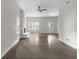 Spacious living room with fireplace, windows, and modern ceiling fan at 772 Brookwood Sw Ter, Lilburn, GA 30047