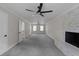 Spacious living room with a fireplace and a ceiling fan at 772 Brookwood Sw Ter, Lilburn, GA 30047