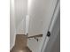 Wood staircase with white walls, and a wooden handrail, with a glimpse of a doorway at 772 Brookwood Sw Ter, Lilburn, GA 30047