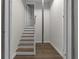 Stairway with wood floors and white trim, leading to the next level at 772 Brookwood Sw Ter, Lilburn, GA 30047