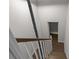 Wooden staircase leading to the upper level of the house, with a door in view at 772 Brookwood Sw Ter, Lilburn, GA 30047