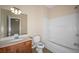 Clean bathroom with vanity, toilet, and shower-tub combination with white tile surround at 1768 Oakbrook Nw Ln # 9, Kennesaw, GA 30152