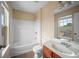 A well-lit bathroom with a tub and shower combo, a single sink vanity, and a large mirror at 1768 Oakbrook Nw Ln # 9, Kennesaw, GA 30152