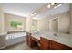 Bright bathroom featuring dual vanities, abundant counter space, a soaking tub, and natural light at 1768 Oakbrook Nw Ln # 9, Kennesaw, GA 30152