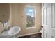 Powder room featuring a pedestal sink, a window, and a white paneled door at 1768 Oakbrook Nw Ln # 9, Kennesaw, GA 30152