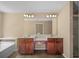 A bathroom featuring double vanities with granite countertops, undermount sinks, and wood cabinetry at 1768 Oakbrook Nw Ln # 9, Kennesaw, GA 30152