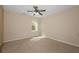 Neutral-toned bedroom with carpet, ceiling fan, and natural light from a window at 1768 Oakbrook Nw Ln # 9, Kennesaw, GA 30152