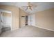 A comfortable bedroom featuring carpet flooring, a ceiling fan, and an en suite bathroom at 1768 Oakbrook Nw Ln # 9, Kennesaw, GA 30152