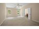 A serene bedroom with natural light, carpet flooring, ceiling fan, and an en suite bathroom at 1768 Oakbrook Nw Ln # 9, Kennesaw, GA 30152